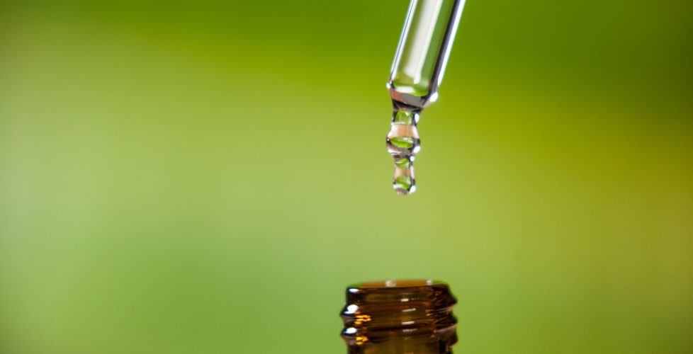 drop-oil-dripping-from-pipette-into-bottle-essential-oil(1)